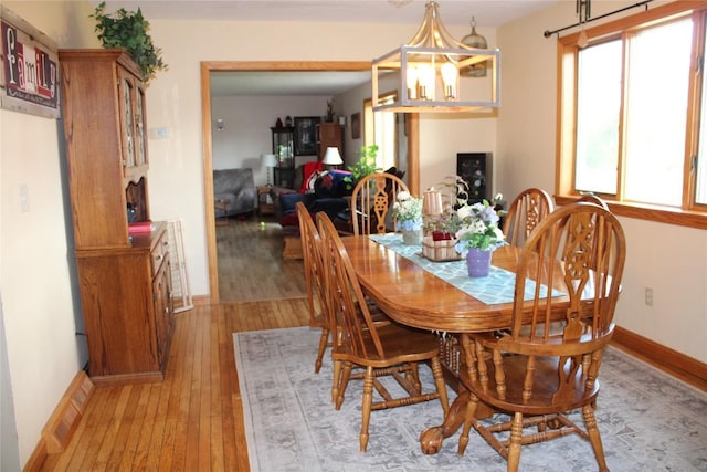 dining room featuring light hardwood / wood-style floors and a notable chandelier