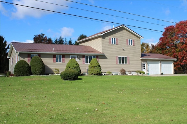 view of front of home with a front yard and a garage