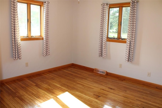 spare room with wood-type flooring