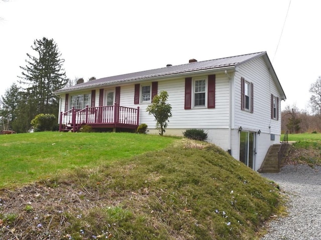 ranch-style home with a front yard, a chimney, and gravel driveway