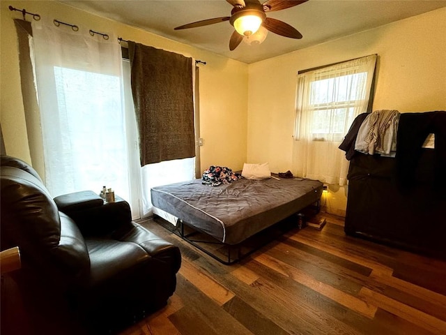 bedroom featuring ceiling fan and dark hardwood / wood-style floors