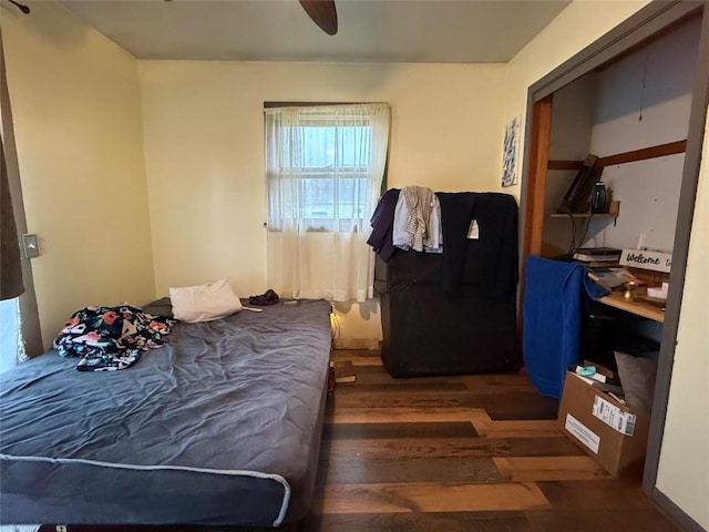 bedroom with dark hardwood / wood-style floors and ceiling fan