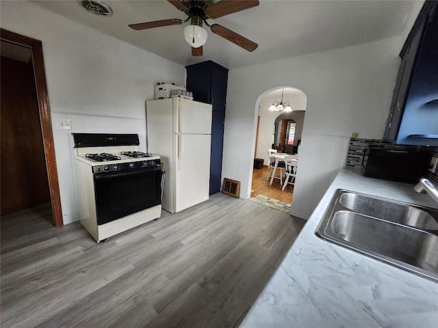 3829 Parade Blvd, Erie, PA 16504 - kitchen featuring range with gas stovetop, freestanding refrigerator, arched walkways, a sink, and ceiling fan