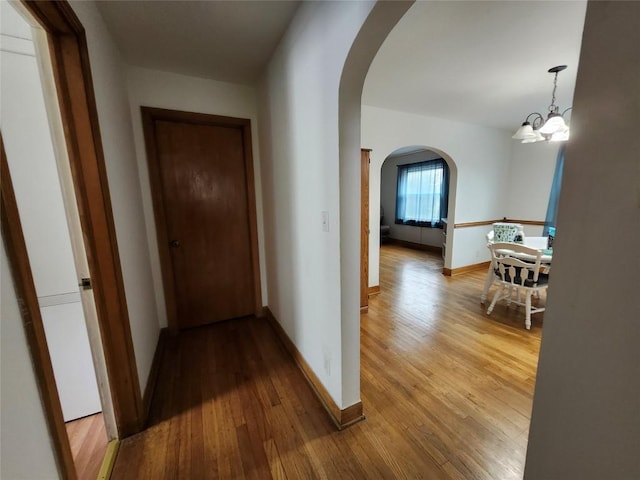 3829 Parade Blvd, Erie, PA 16504 - hall featuring arched walkways, hardwood / wood-style flooring, a chandelier, and baseboards