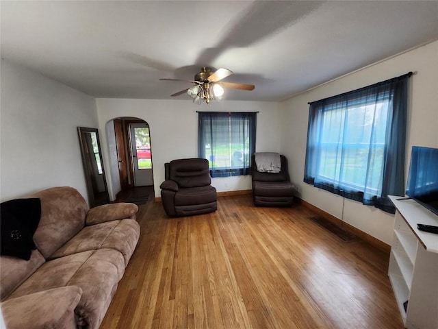 3829 Parade Blvd, Erie, PA 16504 - living room featuring arched walkways, wood finished floors, ceiling fan, and baseboards