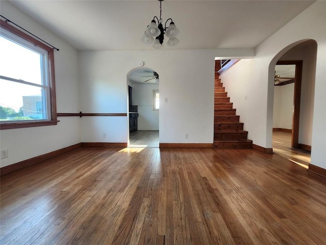 3829 Parade Blvd, Erie, PA 16504 - unfurnished living room with a ceiling fan, arched walkways, hardwood / wood-style flooring, and stairway
