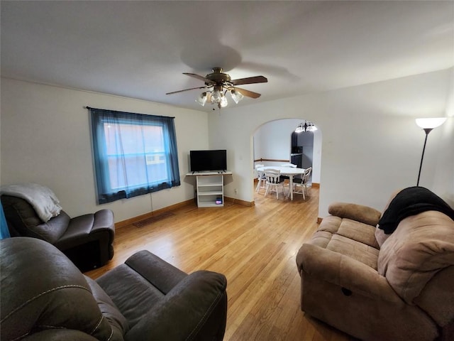 3829 Parade Blvd, Erie, PA 16504 - living area with arched walkways, wood finished floors, ceiling fan, and baseboards