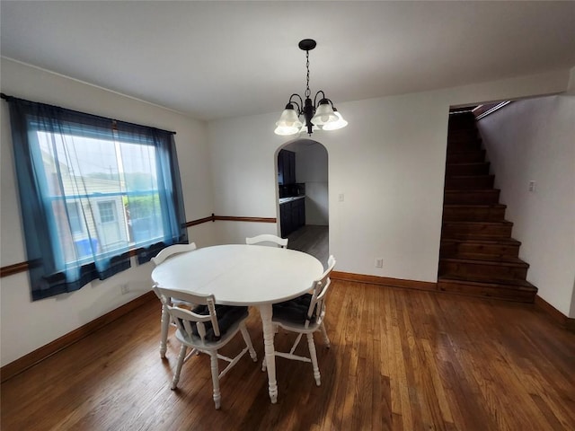 3829 Parade Blvd, Erie, PA 16504 - dining space featuring arched walkways, wood finished floors, baseboards, stairs, and a chandelier