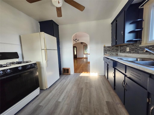 3829 Parade Blvd, Erie, PA 16504 - kitchen featuring black range with gas cooktop, arched walkways, a ceiling fan, light wood-style flooring, and light countertops