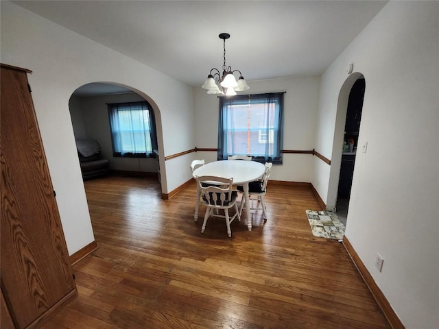 3829 Parade Blvd, Erie, PA 16504 - dining area featuring arched walkways, a chandelier, wood-type flooring, and baseboards