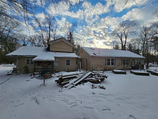 view of snow covered rear of property