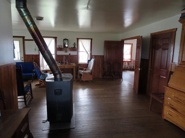 living room featuring dark hardwood / wood-style flooring and a wood stove