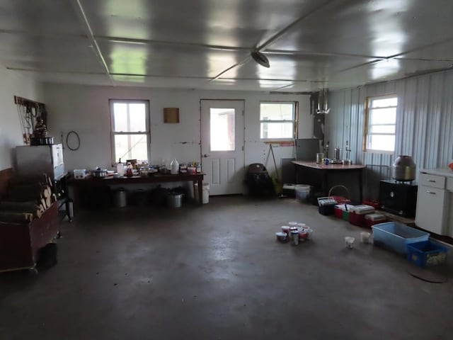 miscellaneous room with a wealth of natural light and concrete floors