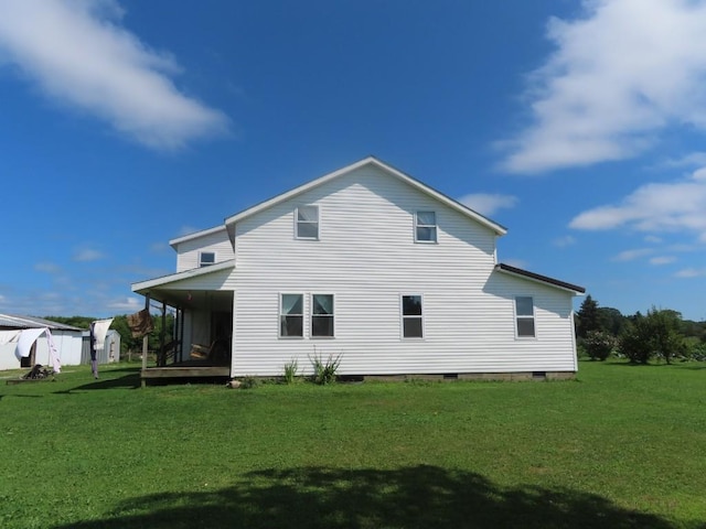 rear view of property featuring a yard