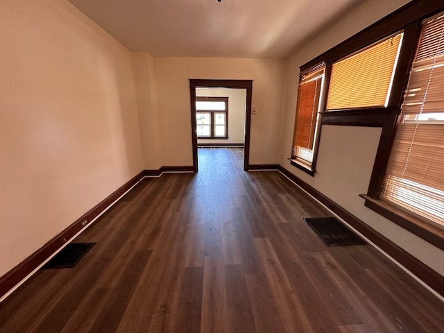 spare room with dark hardwood / wood-style flooring