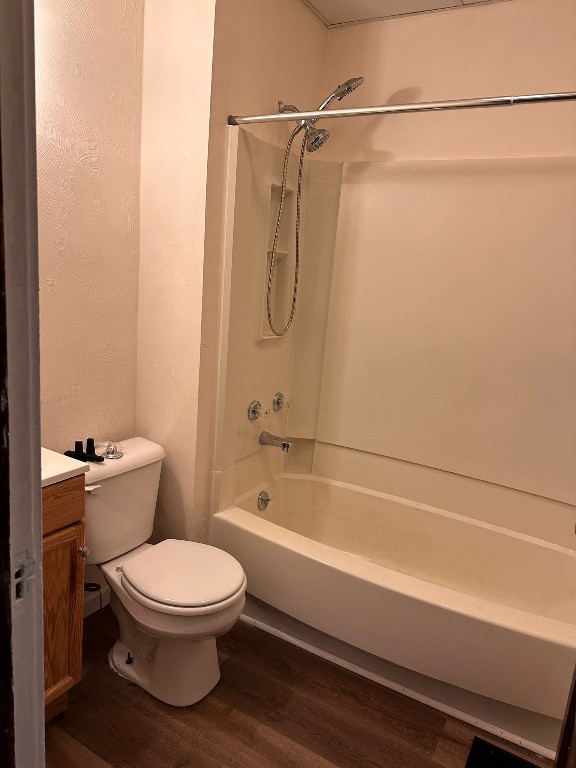 full bathroom featuring vanity, shower / bathtub combination, toilet, and wood-type flooring