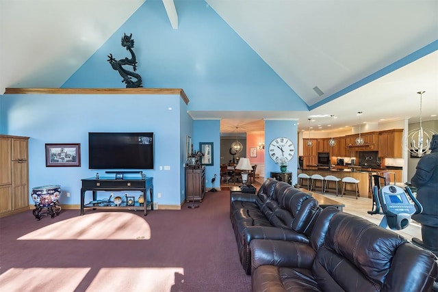 living area featuring a notable chandelier, carpet floors, high vaulted ceiling, and baseboards