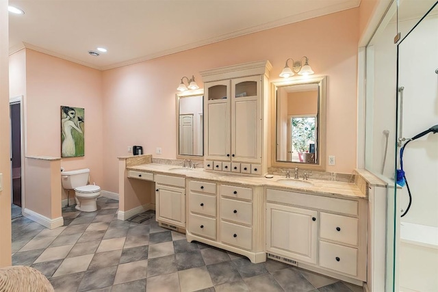 full bath featuring double vanity, toilet, ornamental molding, a sink, and baseboards