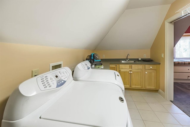 laundry room with cabinet space, washing machine and dryer, light carpet, a sink, and light tile patterned flooring