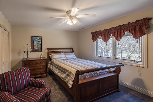 bedroom featuring a ceiling fan, visible vents, baseboards, a closet, and dark carpet