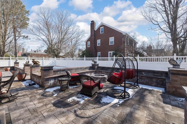 view of patio with a fenced backyard and a fire pit