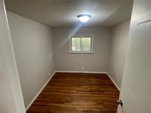 spare room with dark hardwood / wood-style floors