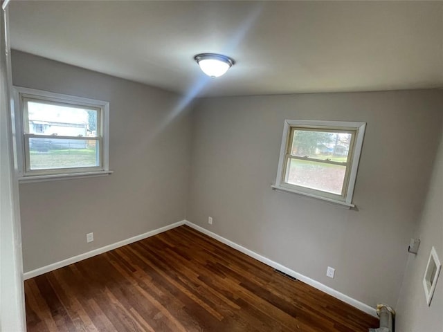 bonus room with dark wood-type flooring