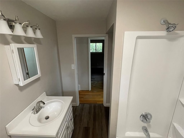 bathroom with vanity, bathtub / shower combination, and hardwood / wood-style flooring