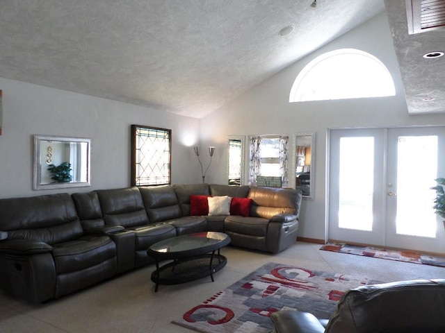 living room featuring high vaulted ceiling, a textured ceiling, and french doors