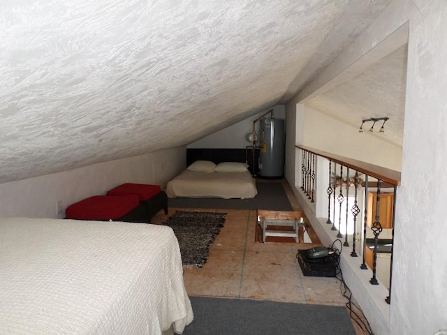 bedroom featuring lofted ceiling, water heater, and a textured ceiling