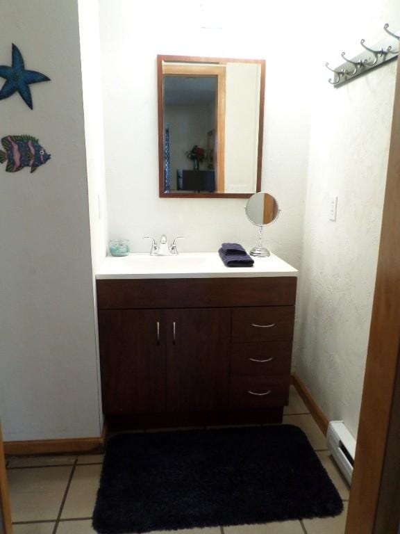 bathroom featuring a baseboard radiator, vanity, and tile patterned flooring