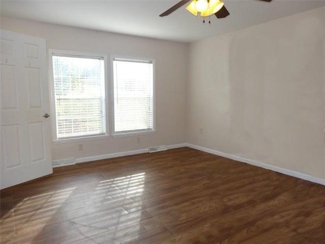 empty room featuring dark hardwood / wood-style floors and ceiling fan