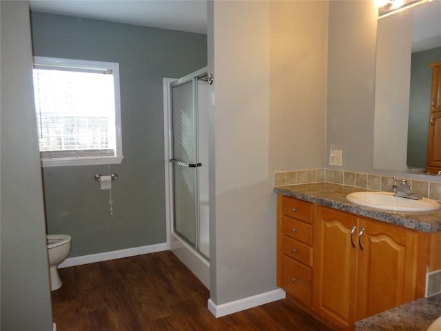 bathroom featuring wood-type flooring, vanity, and toilet