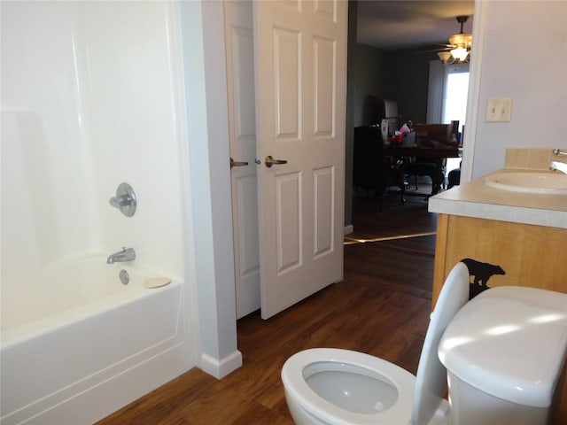 full bathroom with hardwood / wood-style floors, vanity, toilet, and ceiling fan