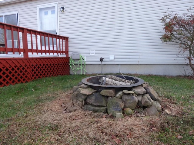 view of yard featuring a fire pit and a wooden deck