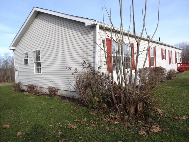 view of property exterior with a lawn