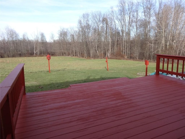 wooden terrace with a lawn