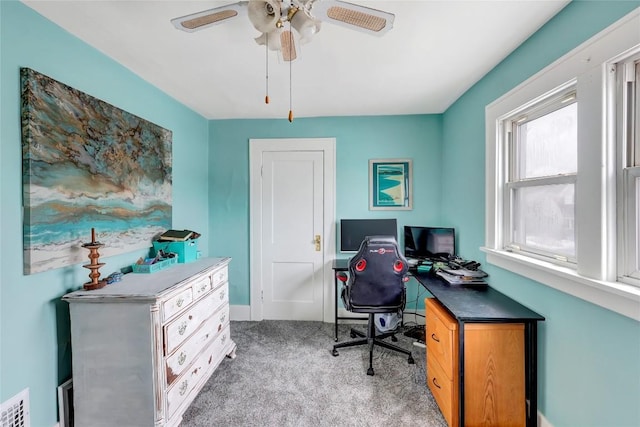 carpeted home office with ceiling fan