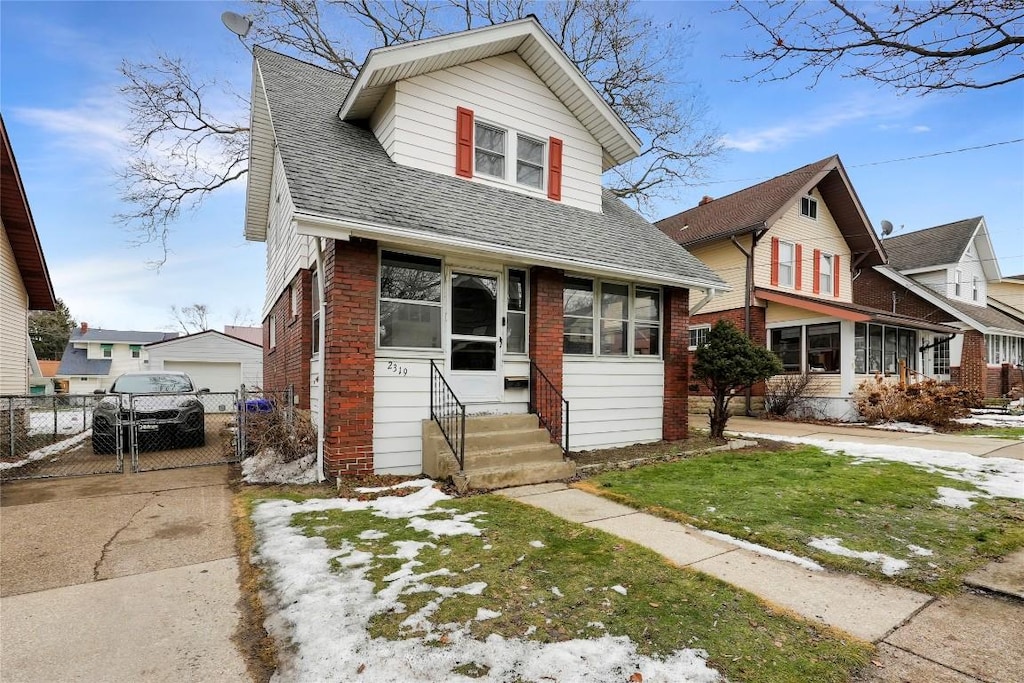 view of front of house with an outbuilding, a garage, and a front yard