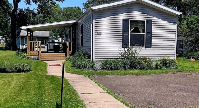 21 Ridgewood Dr, Erie, PA 16426 - view of side of home with a deck and a lawn