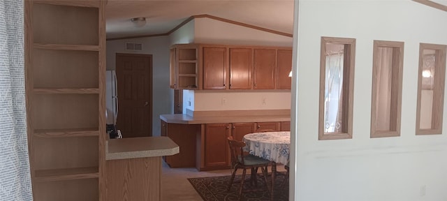 21 Ridgewood Dr, Erie, PA 16426 - kitchen with open shelves, vaulted ceiling, crown molding, freestanding refrigerator, and light countertops