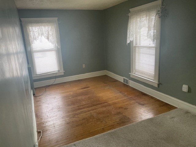 unfurnished room featuring hardwood / wood-style floors