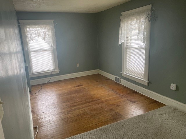 unfurnished room featuring hardwood / wood-style floors