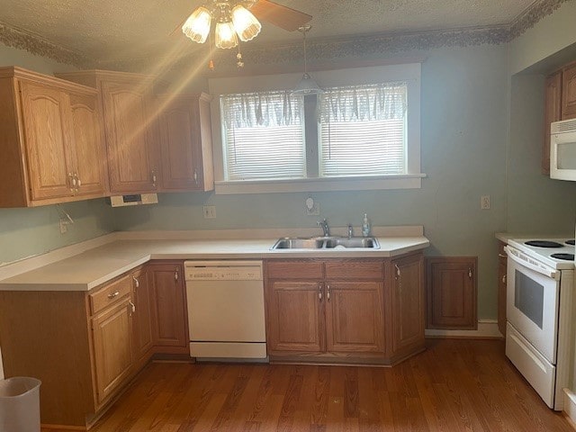 kitchen featuring a textured ceiling, white appliances, and sink