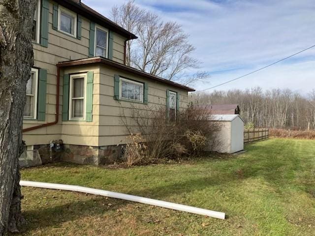 view of side of home with a yard