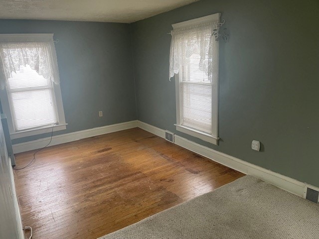 unfurnished room featuring hardwood / wood-style flooring