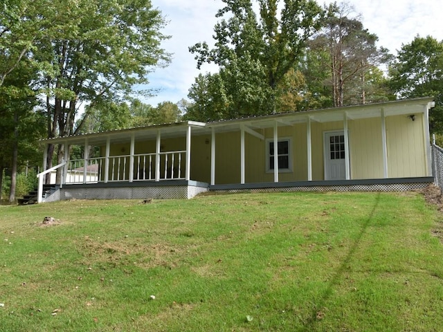 rear view of property with a lawn