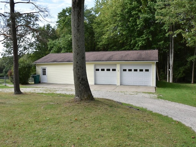 garage featuring a lawn