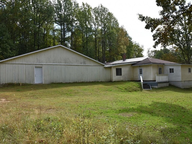 rear view of house with a yard