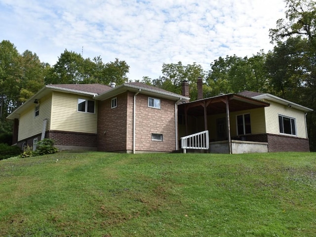 back of house featuring a yard